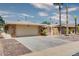 Front view of a single-story home with a two-car garage and landscaped yard at 19434 N 130Th Ave, Sun City West, AZ 85375