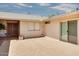 Tiled patio with a wooden dining set, adjacent to the house entrance at 19434 N 130Th Ave, Sun City West, AZ 85375