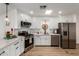 White kitchen with stainless steel appliances and breakfast bar at 429 S 80Th Way, Mesa, AZ 85208