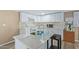 Modern kitchen with white cabinets, quartz countertops, and breakfast bar at 501 E Ray Rd # 211, Chandler, AZ 85225