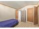 Bedroom with a twin bed, large closet, and wood-look floors at 501 E Ray Rd # 211, Chandler, AZ 85225