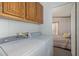 Laundry room with washer, dryer, and built-in cabinets at 501 E Ray Rd # 211, Chandler, AZ 85225