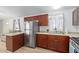 Modern kitchen with stainless steel appliances and dark wood cabinets at 501 E Ray Rd # 211, Chandler, AZ 85225