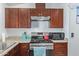 Modern kitchen with stainless steel appliances and dark wood cabinets at 501 E Ray Rd # 211, Chandler, AZ 85225