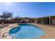 Community pool with lounge chairs and surrounding patio at 501 E Ray Rd # 211, Chandler, AZ 85225