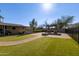 Landscaped backyard with grassy area, fire pit and brick pavers at 501 E Ray Rd # 211, Chandler, AZ 85225