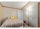 Bedroom with striped bedspread and floor lamp at 501 E Ray Rd # 211, Chandler, AZ 85225