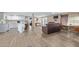 Open concept kitchen and living area with white cabinets, laminate flooring, and modern appliances at 501 E Ray Rd # 211, Chandler, AZ 85225