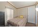 Simple bedroom with striped bedspread and yellow pillow at 501 E Ray Rd # 211, Chandler, AZ 85225