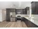 Modern kitchen with dark cabinetry and stainless steel appliances at 14659 N Riverview Ct, Florence, AZ 85132