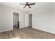 Bedroom with wood-look floors, access to a bathroom, and large closet at 14659 N Riverview Ct, Florence, AZ 85132
