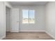 Well-lit bedroom with wood-look floors and a closet at 14659 N Riverview Ct, Florence, AZ 85132