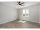 Bright bedroom with wood-look floors and a large window at 14659 N Riverview Ct, Florence, AZ 85132