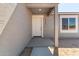 Front entryway with a covered porch and a white front door at 14659 N Riverview Ct, Florence, AZ 85132
