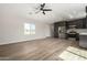 Spacious living room with wood-look floors and ceiling fan at 14659 N Riverview Ct, Florence, AZ 85132