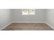 Simple bedroom with wood-look floors and a window at 14659 N Riverview Ct, Florence, AZ 85132