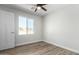 Bright bedroom with wood-look floors and window at 14659 N Riverview Ct, Florence, AZ 85132