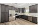 Modern kitchen with dark cabinetry and stainless steel appliances at 14659 N Riverview Ct, Florence, AZ 85132