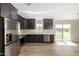 Modern kitchen with dark cabinetry and stainless steel appliances at 14659 N Riverview Ct, Florence, AZ 85132