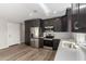 Modern kitchen with dark cabinetry and stainless steel appliances at 14659 N Riverview Ct, Florence, AZ 85132