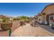 Landscaped backyard with patio, fire pit, and built in grill at 17540 W Glenhaven Dr, Goodyear, AZ 85338