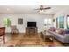 Living room with gray couch, wood flooring, and a rustic coffee table at 17540 W Glenhaven Dr, Goodyear, AZ 85338