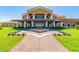 Elegant clubhouse with a fountain and manicured landscaping at 17540 W Glenhaven Dr, Goodyear, AZ 85338