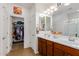 Double vanity bathroom with walk-in closet access at 17540 W Glenhaven Dr, Goodyear, AZ 85338