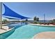 Community pool with shade structures and lounge chairs at 17540 W Glenhaven Dr, Goodyear, AZ 85338