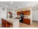 Island kitchen with granite countertops and wood cabinets at 17540 W Glenhaven Dr, Goodyear, AZ 85338