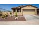 Tan two-car garage home with desert landscaping at 17540 W Glenhaven Dr, Goodyear, AZ 85338
