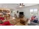 Living room with a view of the kitchen and a gray couch at 17540 W Glenhaven Dr, Goodyear, AZ 85338
