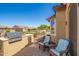 Relaxing backyard patio with built-in grill, fire pit, and comfortable seating at 17540 W Glenhaven Dr, Goodyear, AZ 85338