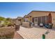 Spacious backyard patio with screened enclosure, built-in grill, and seating at 17540 W Glenhaven Dr, Goodyear, AZ 85338