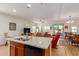 Open concept kitchen with island and views into the living room at 17540 W Glenhaven Dr, Goodyear, AZ 85338