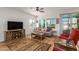 Living room with gray couch, wood flooring, and a rustic coffee table at 17540 W Glenhaven Dr, Goodyear, AZ 85338