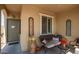Front porch with seating, potted plants and entryway at 17540 W Glenhaven Dr, Goodyear, AZ 85338