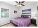 Cozy bedroom with ceiling fan and window at 17540 W Glenhaven Dr, Goodyear, AZ 85338