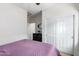 Bedroom with double door closet and ceiling fan at 17540 W Glenhaven Dr, Goodyear, AZ 85338