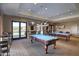 Community game room with two pool tables and comfortable seating at 17540 W Glenhaven Dr, Goodyear, AZ 85338
