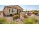 Landscaped backyard with desert landscaping and patio area at 17540 W Glenhaven Dr, Goodyear, AZ 85338