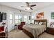 Spacious bedroom with large windows and ceiling fan at 17540 W Glenhaven Dr, Goodyear, AZ 85338