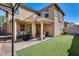 Backyard with covered patio, artificial turf, and pergola at 18535 W Udall Dr, Surprise, AZ 85374