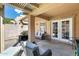 Outdoor patio space with seating and double doors leading to the house at 18535 W Udall Dr, Surprise, AZ 85374