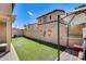 Artificial turf backyard with a covered patio and pergola at 18535 W Udall Dr, Surprise, AZ 85374