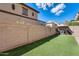 Artificial turf backyard with a block wall and a gazebo at 18535 W Udall Dr, Surprise, AZ 85374