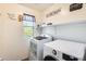 Laundry room with washer, dryer, and shelving at 18535 W Udall Dr, Surprise, AZ 85374