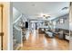 Bright living room with hardwood floors, comfortable seating, and views into the kitchen at 18535 W Udall Dr, Surprise, AZ 85374
