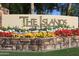 The Islands community entrance, featuring a stone wall and colorful flowers at 514 S Marina Dr, Gilbert, AZ 85233