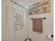 Small bathroom with shower, rustic decor, and vintage-style soap and water sign at 21151 E Mewes Rd, Queen Creek, AZ 85142
